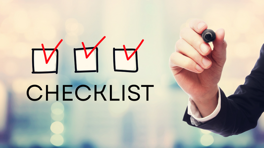 Checklist with red checkmarks and a person holding a pen, symbolizing quality control, proper protocol, and success in plant tissue culture – Itsumi Botanicals 2025